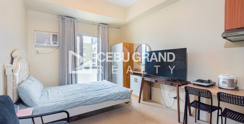 Furnished 25 sqm studio at Avida Riala Tower 3 with bed, TV console and dining desk