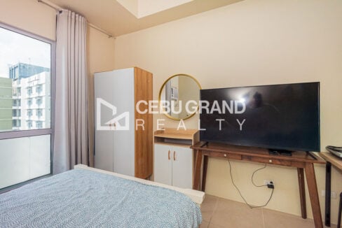 Two-door wardrobe, round gold mirror and flat-screen TV on a walnut console