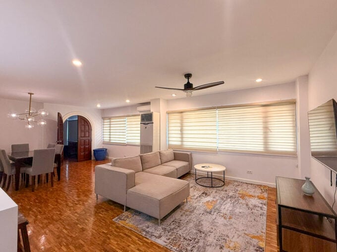 Living room at Regency Crest, Banilad, with an L-shaped sofa, ceiling fan and parquet floors