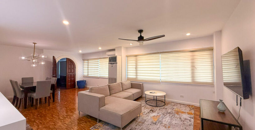 Living room at Regency Crest, Banilad, with an L-shaped sofa, ceiling fan and parquet floors