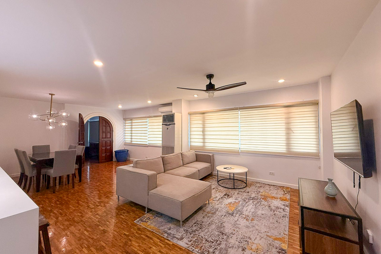 Living room at Regency Crest, Banilad, with an L-shaped sofa, ceiling fan and parquet floors