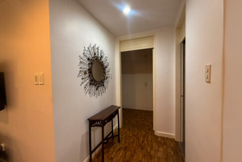 Hallway with a sunburst mirror and a wooden console table