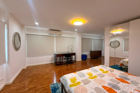 Master bedroom with a study desk, mirrored wardrobe and roller blinds