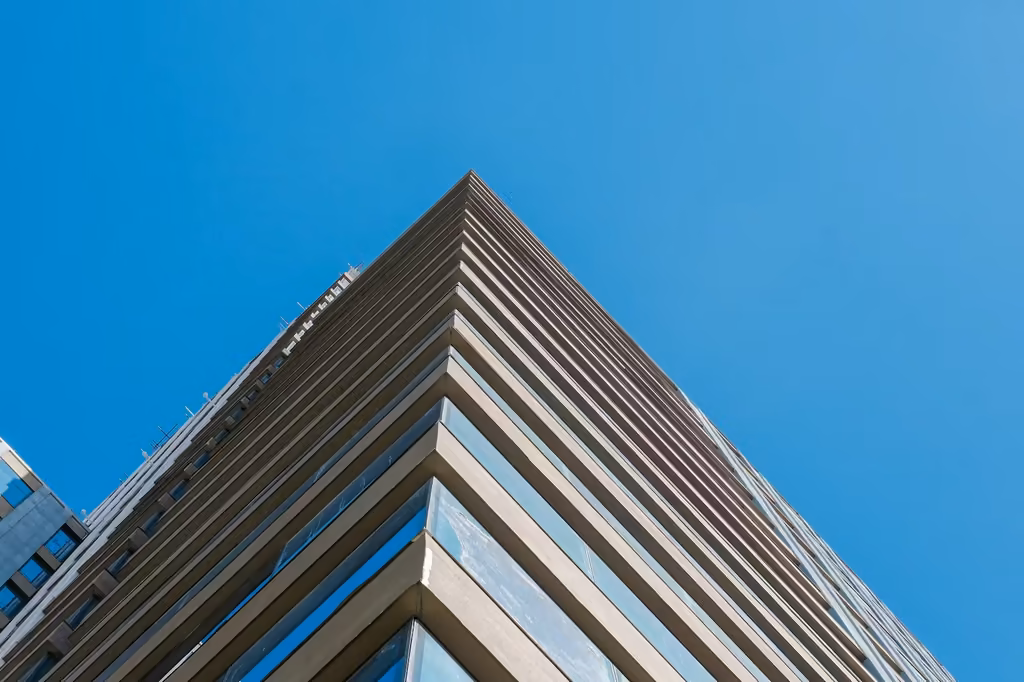 Looking up at a corner of the Cebu Exchange Tower facade against a blue sky
