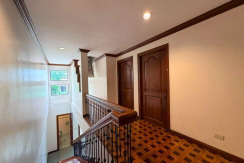 Upper landing with parquet floors, wooden bedroom doors and a railing over the stairwell