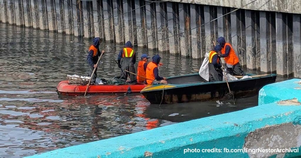 Workers in small boats cleaning debris from a waterway as part of the Oplan Kontra Baha Metro Cebu flood control project.
