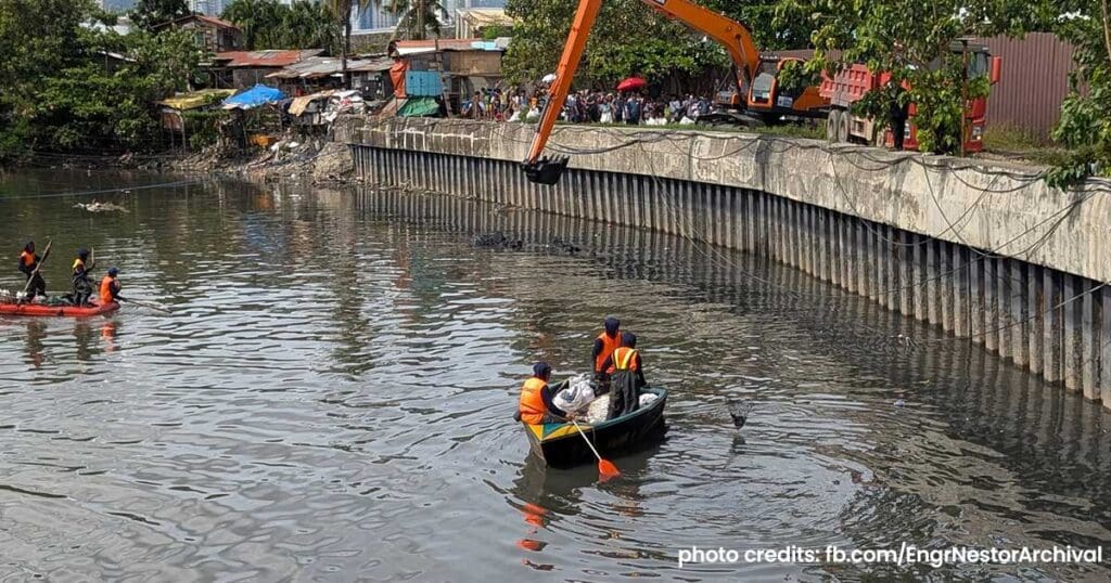 Crew members on small boats clearing waste from the waterway for the Oplan Kontra Baha Metro Cebu flood control project.
