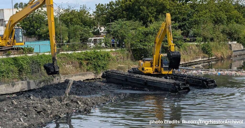 Excavator digging and moving soil at a construction site for the Oplan Kontra Baha Metro Cebu flood control project