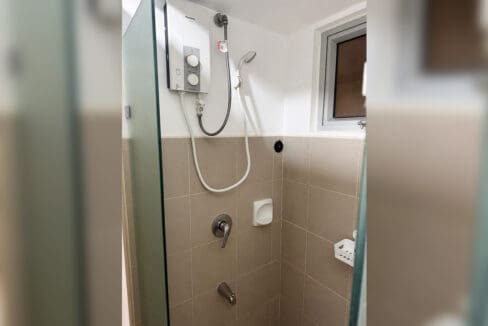 Shower with water heater and glass enclosure