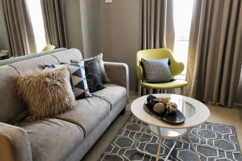 Sofa and round coffee table on a patterned rug in the living area