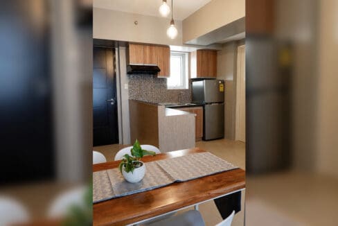 Kitchen with timber cabinets, range hood and stainless refrigerator