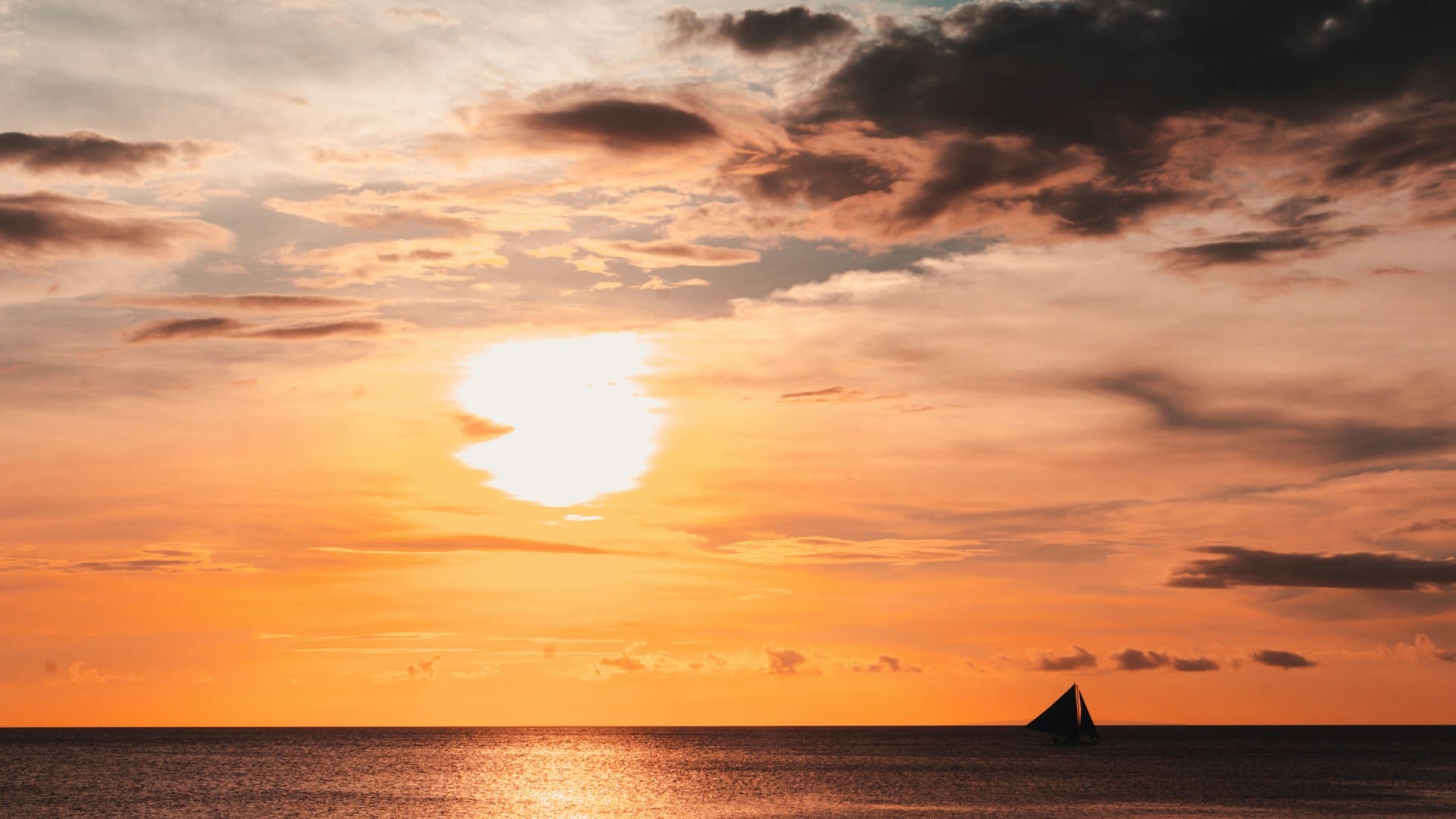 People enjoying the beach during sunset in Malay, Philippines