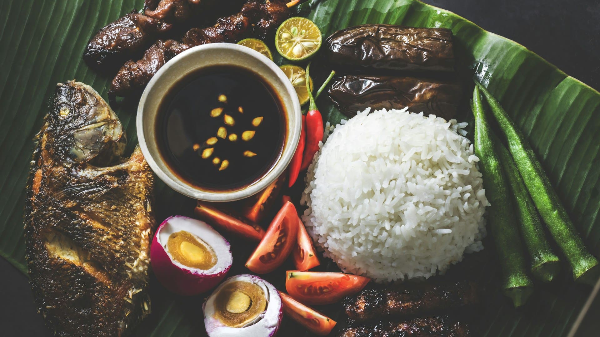 Variety of Filipino fried dishes served on banana leaf in the Philippines