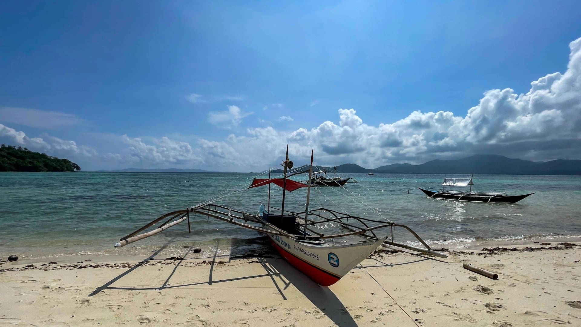 Traditional Filipino outrigger bangka boat on a sandy beach