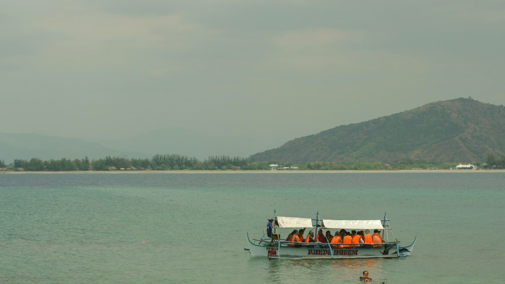 People riding a boat on the sea in the Philippines
