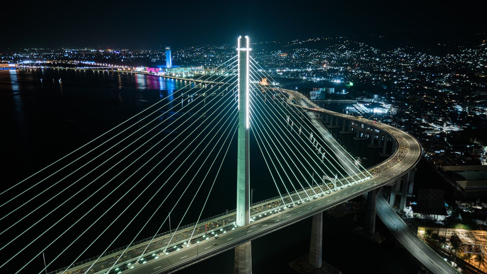 Illuminated suspension bridge over Cebu City waterway at night Philippines