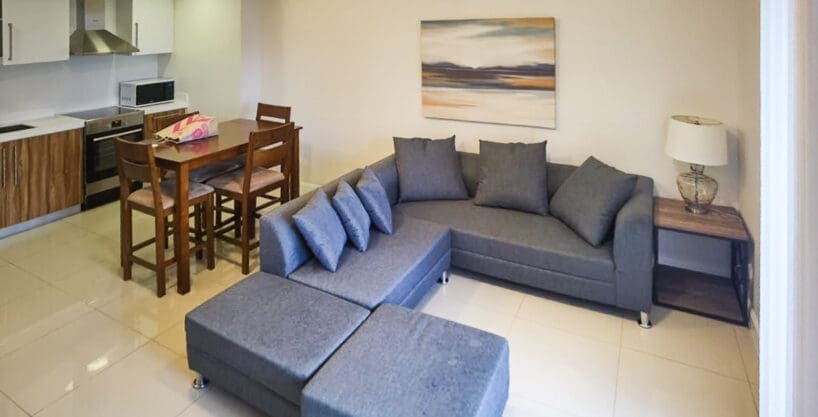 Fully-furnished Alcoves condo for rent — kitchen, dining, and living view