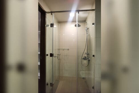 Alcoves condo for rent — modern glass-enclosed rain-shower bath