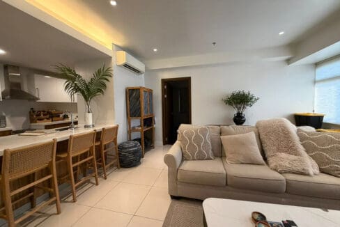 Kitchen bar with rattan barstools and Panasonic double-door fridge at The Alcoves 1BR
