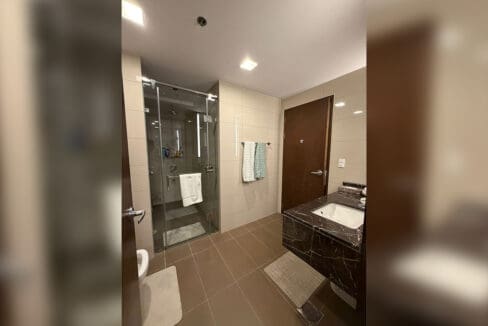 Utility area with stacked Samsung washer and dryer at brand-new 1BR at The Alcoves