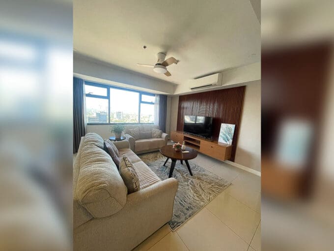Kitchen with Tecnogas range, marble backsplash, and stainless refrigerator at Alcoves 2BR