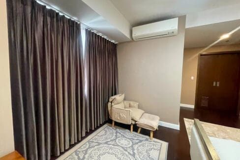 Master bedroom with king bed, workspace, and Cebu Business Park view at Alcoves 2BR