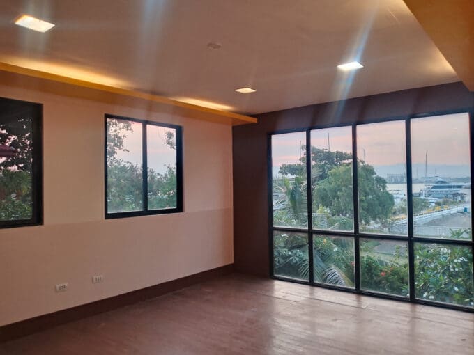 Second-floor office space for rent in Lapu-Lapu with full-height glazing and water views at Cebu Yacht Club