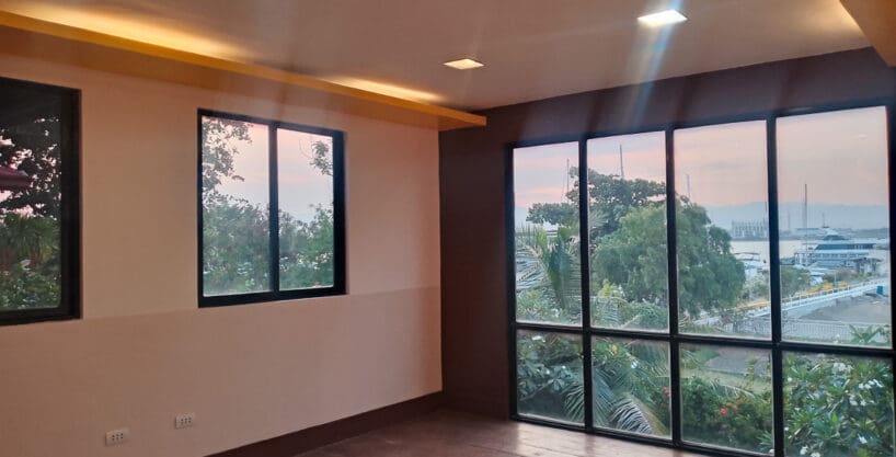 Second-floor office space for rent in Lapu-Lapu with full-height glazing and water views at Cebu Yacht Club