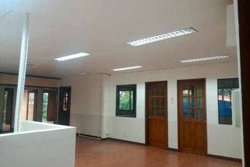 Open office floor with front counter and wood-look flooring at Cebu Yacht Club in Ibo, Lapu-Lapu