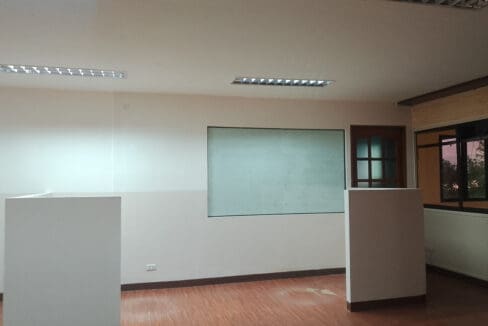 Work area with wall whiteboard, partitions and windows in the 150 sqm office for rent in Lapu-Lapu