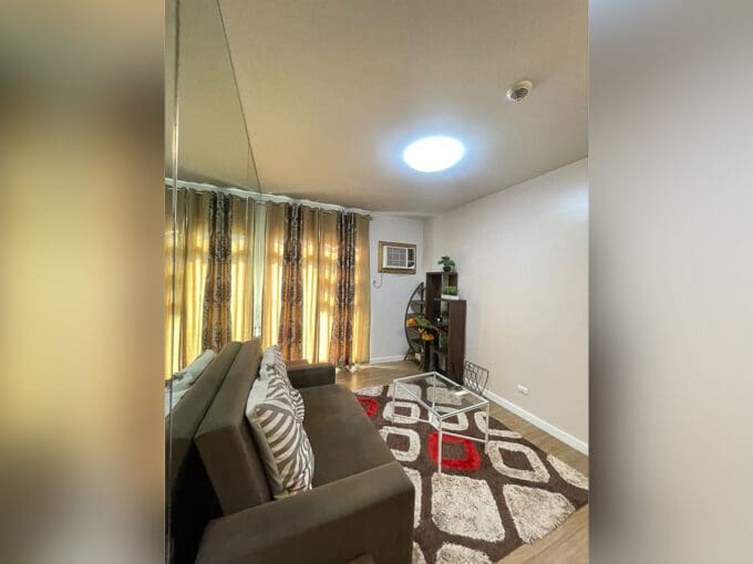 Bedroom with Murphy bed and side lamps at Solinea Tower 1 1BR