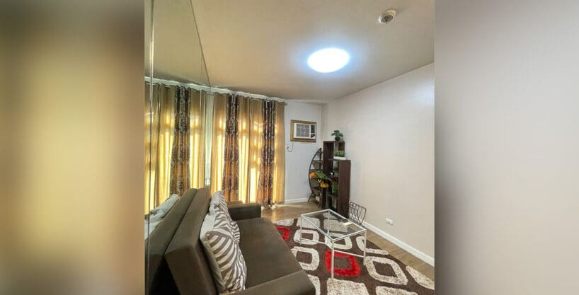 Bedroom with Murphy bed and side lamps at Solinea Tower 1 1BR