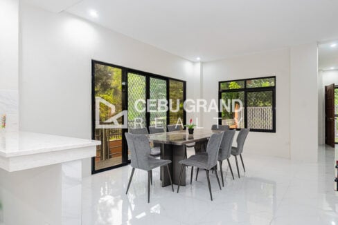Dining area with sliding glass doors and windows looking out to the trees