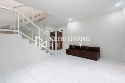 Family area with a sofa bed and wood panel bedroom doors