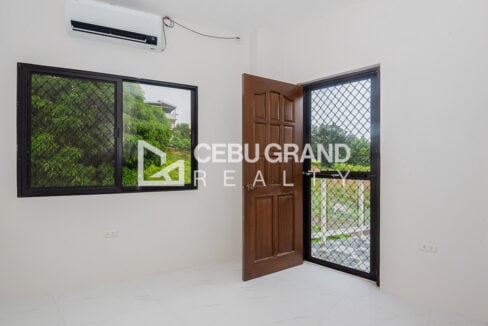 Bedroom with split-type aircon and a screened door to the balcony