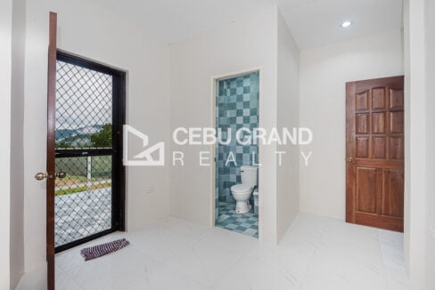 Room with a door to the balcony and its own blue-tiled toilet