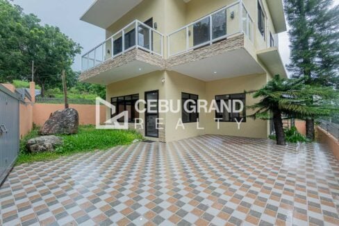 Tiled parking court and ground-floor entrance under the balconies