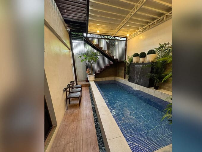 Main entrance foyer with plant and chair at 7BR compound house Cebu City