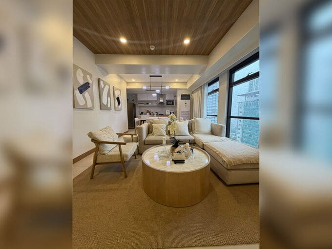 Alcoves condo for sale — mirror-walled entry foyer with curated art