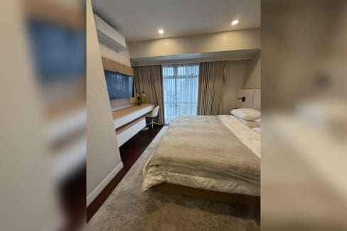 Alcoves condo for sale — master bedroom with king bed and city view