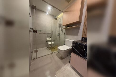 Alcoves condo for sale — media zone with hardwood floors