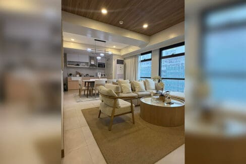 Fully-furnished bi-level Alcoves condo for sale — open-plan living to kitchen