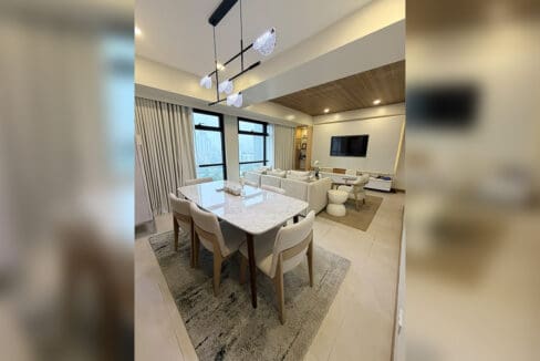Alcoves condo for sale — marble dining under designer chandelier