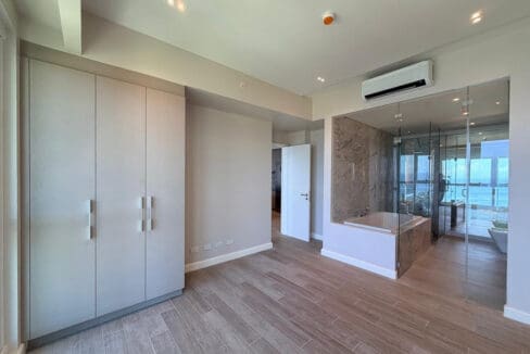 Master bath with soaking tub and glass-enclosed rain shower at Aruga Resort