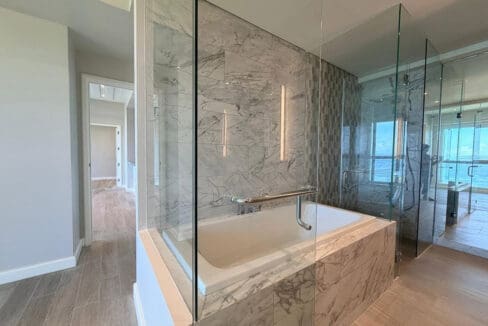Master bath with marble double vanity and sea view at Aruga Resort