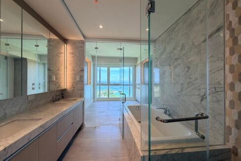 Master vanity double sinks with mirrors and marble at Aruga Resort 2BR