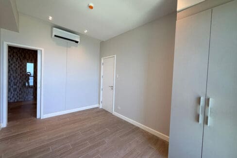 Powder room with marble walls at Aruga Resort 2BR condo