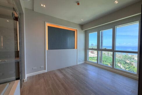 Open kitchen and living area with chevron backsplash at Aruga Resort 2BR