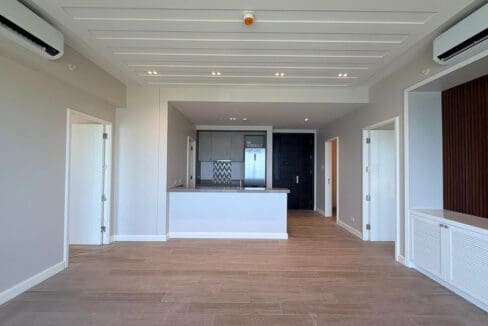 Kitchen island with quartz counter and chevron backsplash at Aruga 2BR beachfront