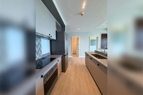 Living area with wooden slat TV feature wall at Aruga Resort 2BR